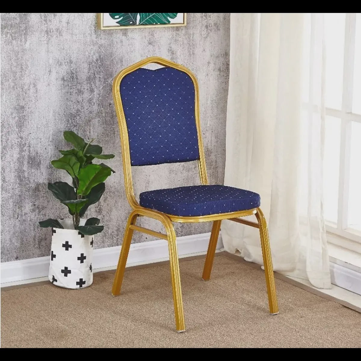 Royal blue patterned banquet chair in a bright room beside a plant