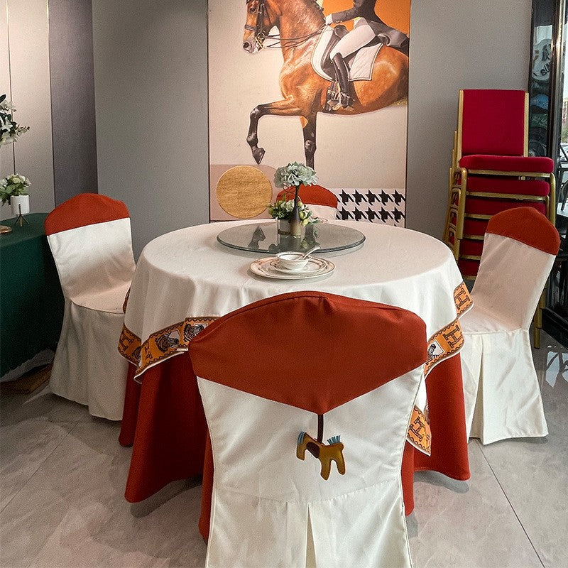 Round banqueting table dressed with a white tablecloth for an event